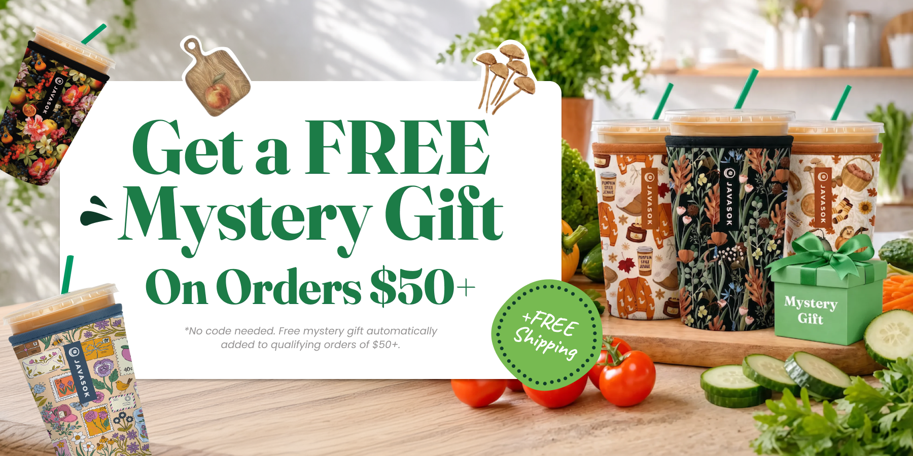 Promotional banner for a free mystery gift on orders $50+, featuring multiple illustrated takeaway cups and a small green gift box on a kitchen counter with vegetables and herbs. Large text reads 'Get a FREE Mystery Gift On Orders $50+' with a green 'FREE Shipping' badge.