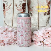 pink floral and cowgirl boot pattern can sleeve on silver skinny can with boots and flowers in the background